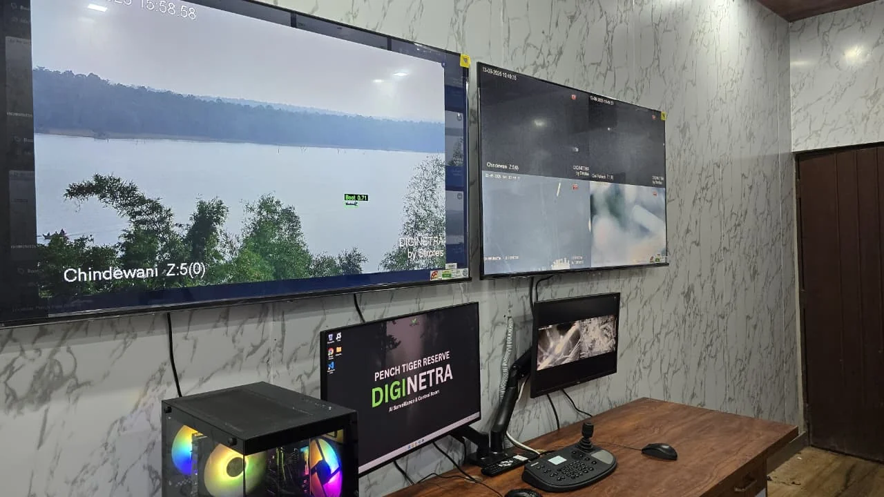 The Pench control room with Mirage on the wall display: a daytime view across Totladoh Dam from the Chindewani camera, with a boat on the water ringed by a green detection box labelled “Boat 0.71”.
