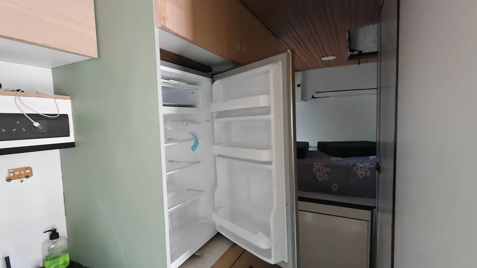 The on-board refrigerator open, built into the utility run.