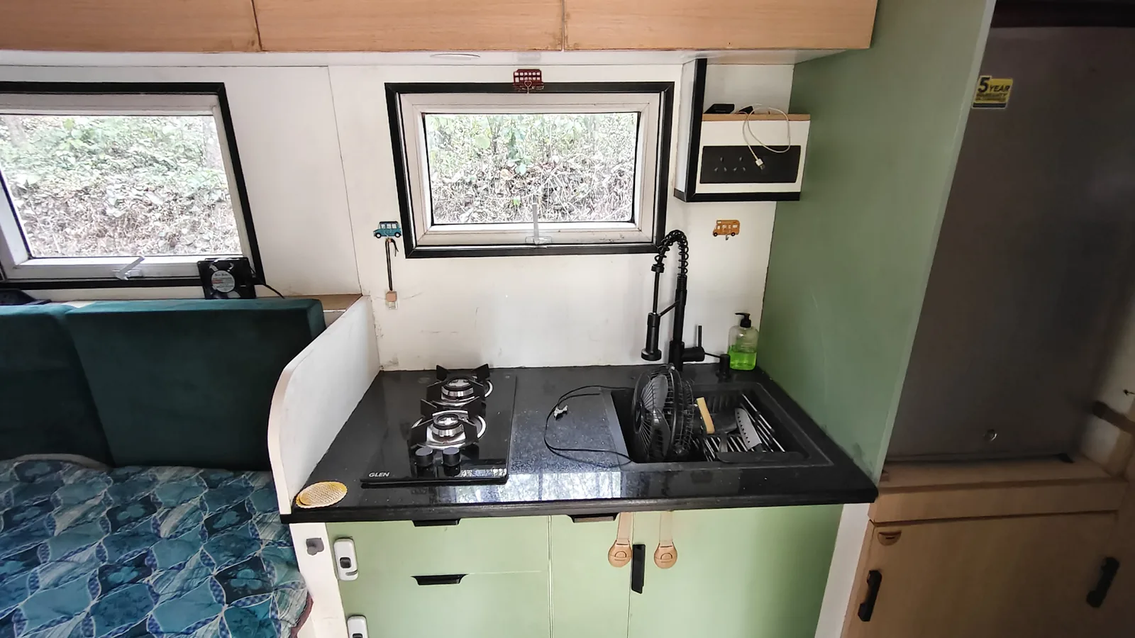 The galley kitchen with gas hob and microwave, looking through to the bed area.